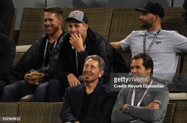 Jared Goff quarterback of the Los Angeles Rams seated behind Oracle Co-founder Larry Ellison and tournament director Tommy Hass attend Naomi Osaka of...