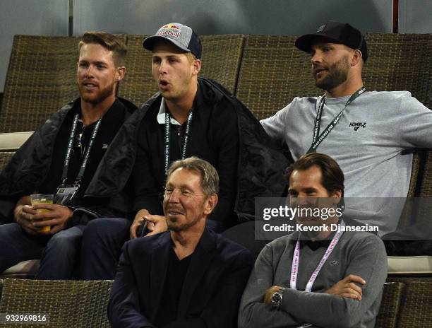 Jared Goff quarterback of the Los Angeles Rams seated behind Oracle Co-founder Larry Ellison and tournament director Tommy Hass attend Naomi Osaka of...