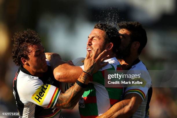 Sam Burgess of the Rabbitohs is tackled by James Fisher-Harris and James Tamou of the Panthers during the round two NRL match between the Penrith...