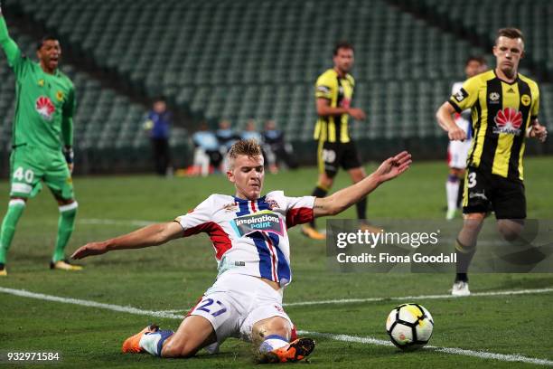 Riley McGree of the Newcastle Jets slides for the ball during the round 23 A-League match between the Wellington Phoenix and the Newcastle Jets at...