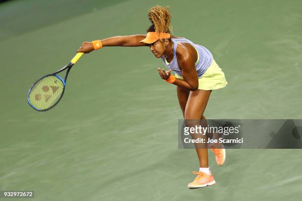 Naomi Osaka of Japan serves to Simona Halep of Romania during their semifinal match at the BNP Paribas Open - Day 12 on March 16, 2018 in Indian...