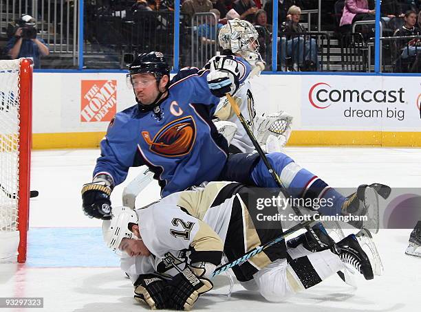 Ilya Kovalchuk of the Atlanta Thrashers is upended by Christopher Bourque of the Pittsburgh Penguins at Philips Arena on November 21, 2009 in...