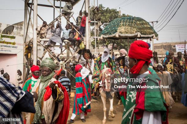 Kano, Nigeria- The Emir of Kano, Muhammed Sanusi II, surrounded by his guards and aides, rides his horse to the Fatahul Mubin Islamic School...