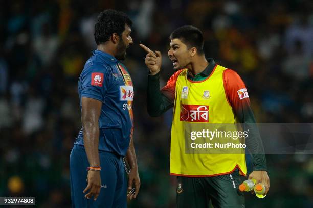 Sri Lankan cricket captain Thisara Perera and Bangladesh cricketer Nurul Hasan are seen in a conversation during 6th T20 cricket match of NIDAHAS...