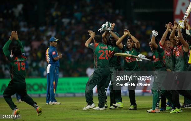 Bangladesh cricket team and management staff dance in celebration after their victory over Sri Lanka during the 6th T20 cricket match of NIDAHAS...