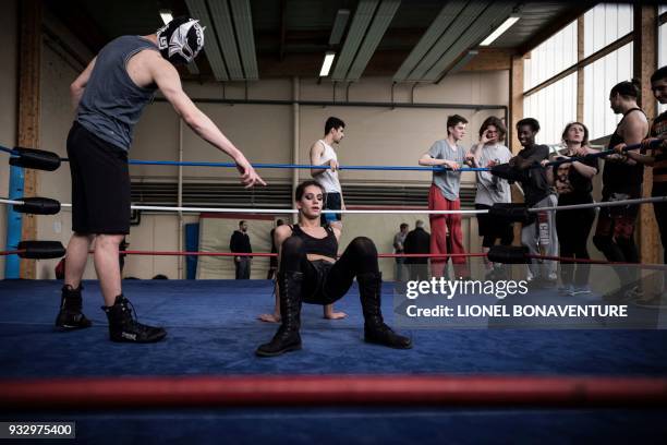 Wrestlers are pictured during a training session on March 10 in Nanterre, near Paris. In Nanterre, the French Association of Professional Wrestling...