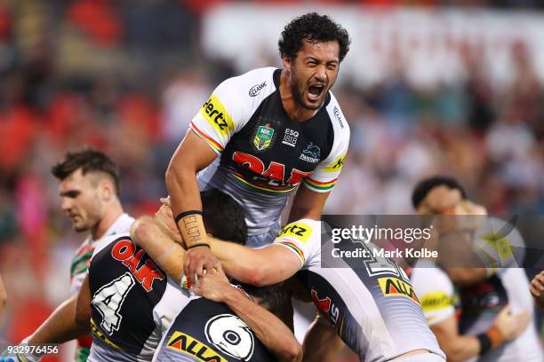 Corey Harawira-Naera of the Panthers jumps on his team mates as they celebrate Tyrone Peachey of the Panthers scoring a try during the round two NRL...