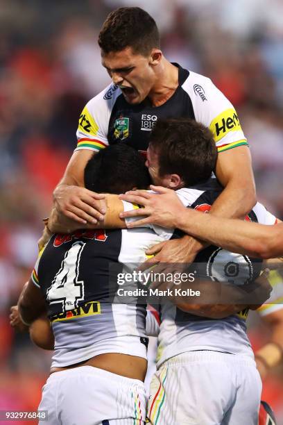 Tyrone Peachey, Nathan Cleary and James Maloney of the Panthers celebrate after Tyrone Peachey of the Panthers scored a try during the round two NRL...