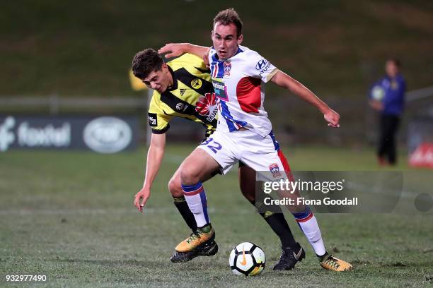 Liberato Cacace of the Wellington Phoenix tackles Angus Thurgate of the Newcastle Jets during the round 23 A-League match between the Wellington...