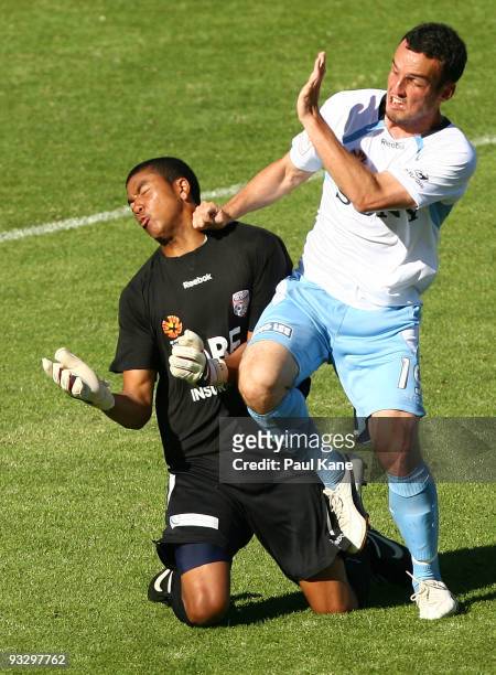 Tando Velaphi of the Glory and Mark Bridge of Sydney collide during the round 15 A-League match between Perth Glory and Sydney FC at ME Bank Stadium...