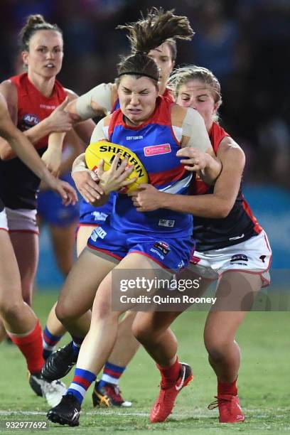 Kirsty Lamb of the Bulldogs is tackled by Katherine Smith of the Demons during the round seven AFLW match between the Western Bulldogs and the...