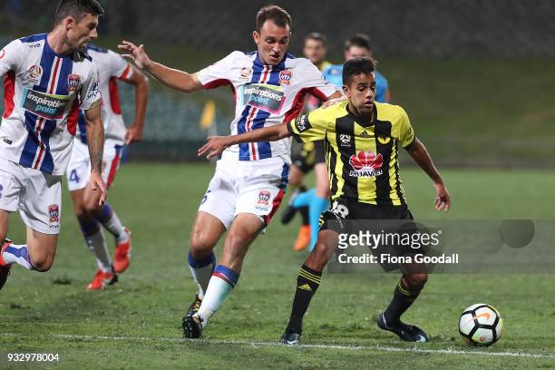 Sarpreet Singh of the Wellington Phoenix is tackled by Steven Ugarkovic of the Newcastle Jets during the round 23 A-League match between the...