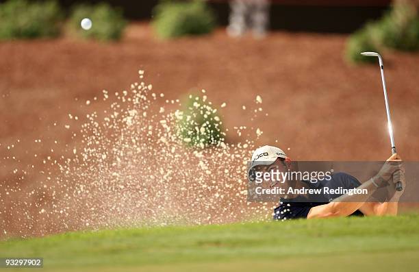 Martin Kaymer of Germany plays from a bunker on the 17th hole during the final round of the Dubai World Championship on the Earth Course, Jumeirah...