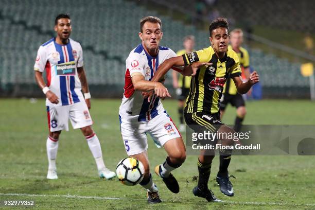 Sarpreet Singh of the Wellington Phoenix is defended by Benjamin Kantarovski of the Newcastle Jets during the round 23 A-League match between the...