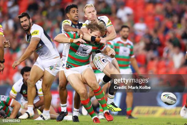 George Burgess of the Rabbitohs is tackled by Tyrone Peachey and Peter Wallace of the Panthers during the round two NRL match between the Penrith...