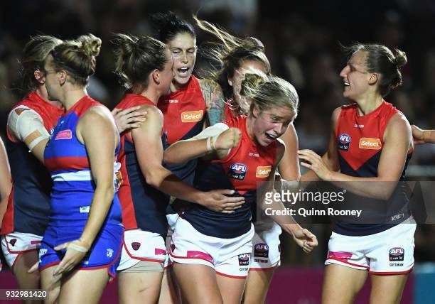 Katherine Smith of the Demons is congratulated by team mates after scoring a goal during the round seven AFLW match between the Western Bulldogs and...