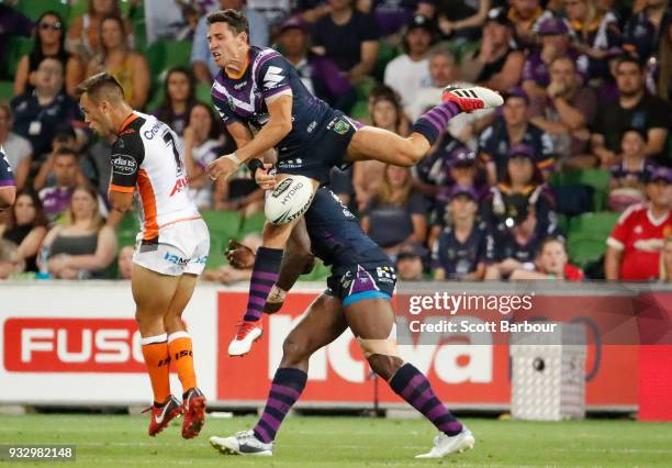 Billy Slater of the Melbourne Storm drops a high ball as he collides with Suliasi Vunivalu of the Melbourne Storm during the round two NRL match...