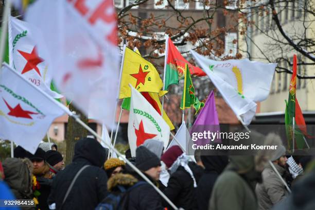 Expatriate Kurds carry flags showing YPG flags as they participate in celebrations marking the Kurdish new year, or Newroz, on March 17, 2018 in...