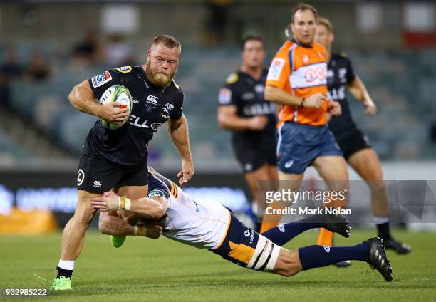 Akker van der Merwe of the Sharks is tackled during the round five Super Rugby match between the Brumbies and the Sharks at GIO Stadium on March 17,...