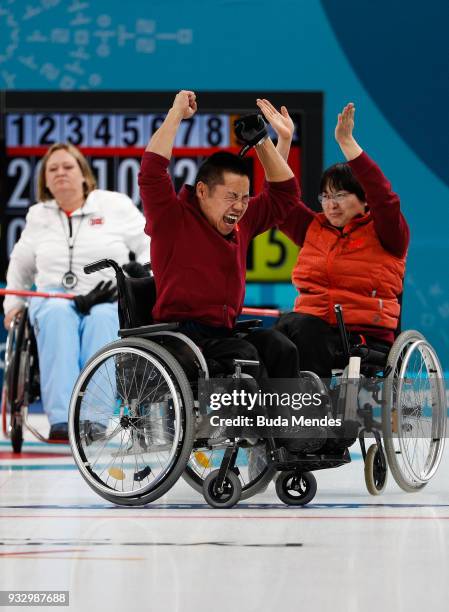 Wang Meng of China and Liu Wei of China celebrate after defeating Norway in the Curling Mixed Golden Medal match between China and Norway during day...