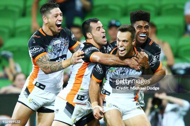 Luke Brooks of the Tigers celebrates a try in the dying stages during the round two NRL match between the Melbourne Storm and the Wests Tigers at...