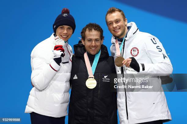 Silver Medallist Arthur Bauchet of France, Gold Medallist Adam Hall of New Zealand and Bronze Medallist Jamie Stanton of the United States celebrate...