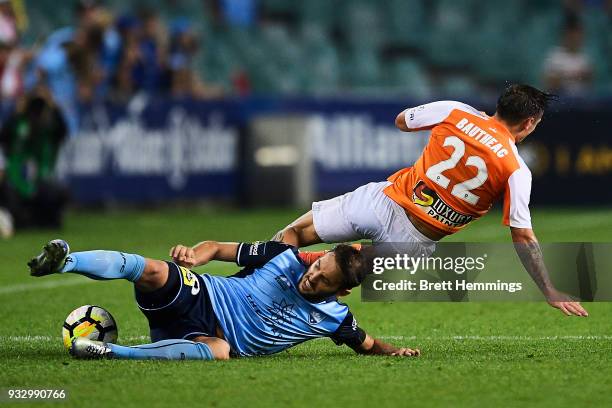 Eric Bautheac of Brisbane is tackled Milos Ninkovic of Sydney during the round 23 A-League match between Sydney FC and the Brisbane Roar at Allianz...