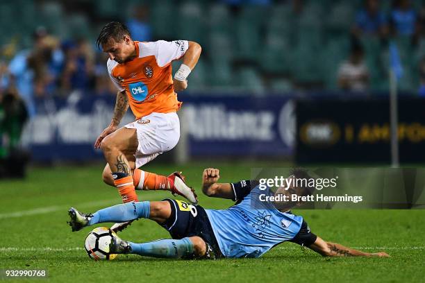 Eric Bautheac of Brisbane is tackled Milos Ninkovic of Sydney during the round 23 A-League match between Sydney FC and the Brisbane Roar at Allianz...