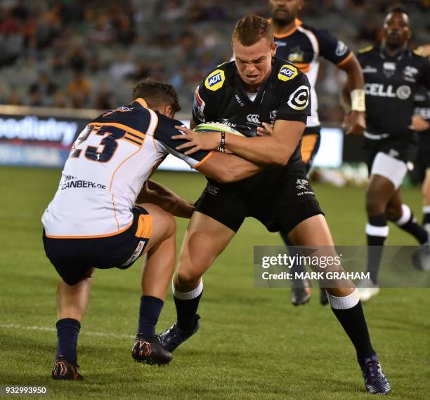 Sharks player Curwin Bosch is tackled by Brumbies player Tevita Kuridrani during the Super Rugby match between the ACT Brumbies and the South African...