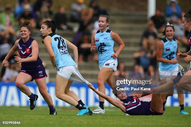 Alex Williams of the Dockers holds on to Katie-Jayne Grieve of the Blues after a tackle during the round seven AFLW match between the Fremantle...