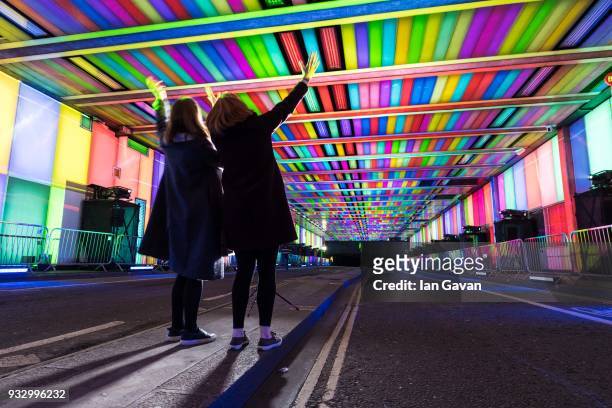 People stop by to watch Culture Mile presents "Tunnel Visions: Array" created by 59 Productions as part of Barbican OpenFest on March 17, 2018 in...