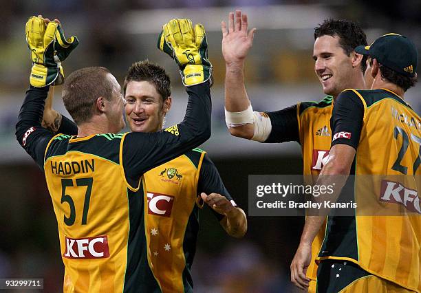 Brad Haddin, Michael Clarke and Shaun Tait of Australia celebrate a wicket during the Twenty20 exhibition match between Australia and the ACA...