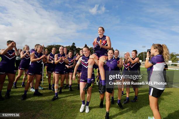 Amy Lavell of the Dockers is chaired off by Kara Donnellan and Kiara Bowers after the round seven AFLW match between the Fremantle Dockers and the...