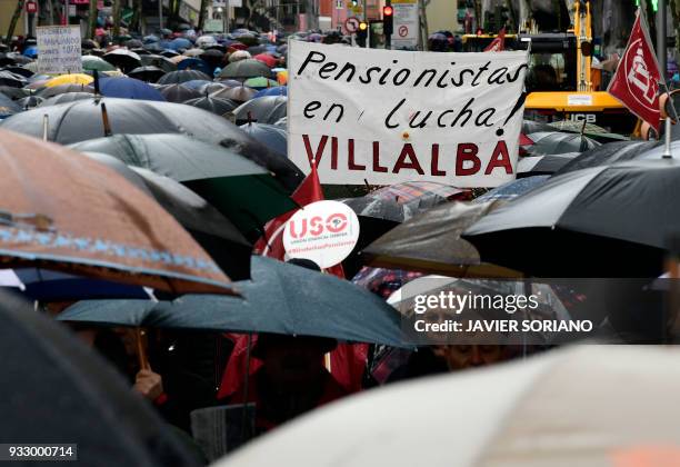 Demonstrators hold a banner reading "Pensioners in the fight!" in Madrid on March 17 during a protest called by the main Spanish unions and the...
