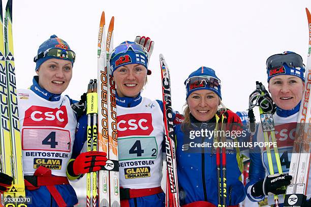 Finland's Pirjo Mauranen, Virpi Kuitunen, Riitta-Liisa Roponen and Aino Kaisa Saarinen pose after finishing in third place at the FIS cross country...