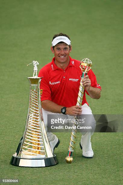 Lee Westwood of England poses with the Dubai World Championship and the Race to Dubai trophies after his victory in the final round of the Dubai...