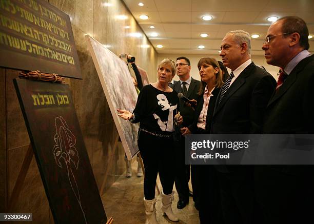 Israeli Prime Minister Benjamin Netanyahu and Deputy Prime Minister Silvan Shalom look at artwork displayed at the Prime Ministry, to commemorate the...