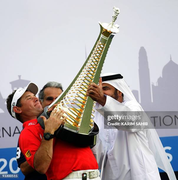 England's Lee Westwood raises his trophy after winning the Dubai World Championship at the Earth Course at Jumeirah Golf Estates in Dubai on November...