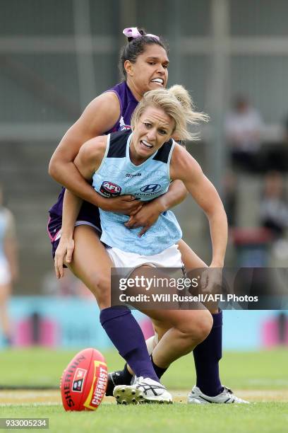 Katie Loynes of the Blues is tackled by Alicia Janz of the Dockers during the round seven AFLW match between the Fremantle Dockers and the Carlton...