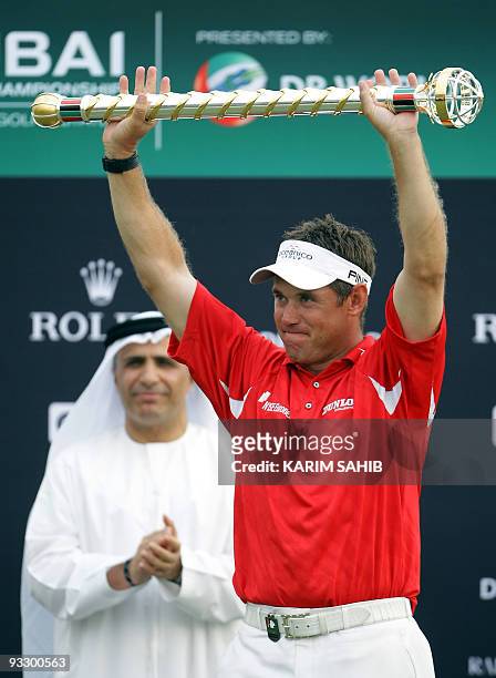 England's Lee Westwood raises a trophy after winning the Dubai World Championship at the Earth Course at Jumeirah Golf Estates in Dubai on November...