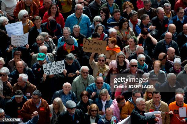 Pensioners march in Barcelona on March 17 during a protest called by 'Marea Pensionista' and supported by the main Spanish unions, demanding decent...