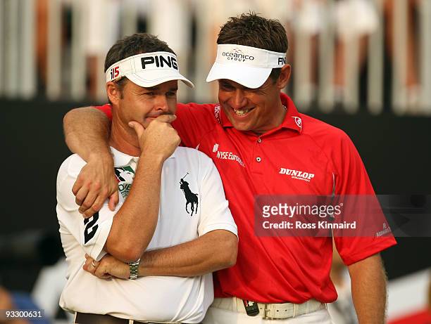 Lee Westwood of England and his caddie Billy Foster celebrate after winning the Dubai World Championship and The Race to Dubai on the Earth Course,...