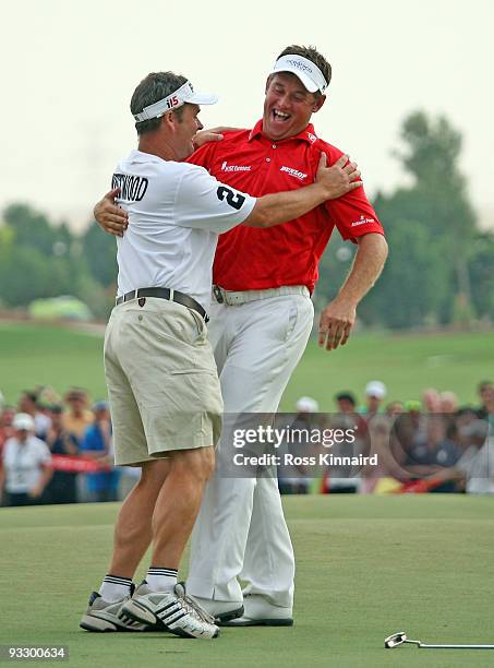 Lee Westwood of England and his caddie Billy Foster celebrate after winning the Dubai World Championship and The Race to Dubai on the Earth Course,...