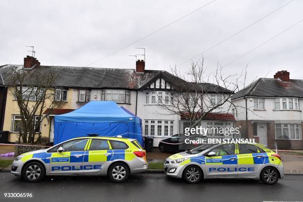 Police forensics tents and vehicles are seen in front of the home where Russian exile Nikolai Glushkov lived in southwest London on March 17, 2018...