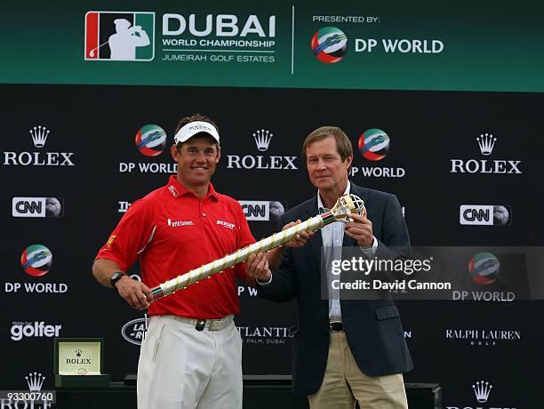 Lee Westwood of England is presented with the Dubai World Championship Trophy by George O'Grady the Chief Executive of the European Tour after his...