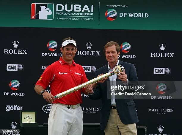 Lee Westwood of England is presented with the Dubai World Championship Trophy by George O'Grady the Chief Executive of the European Tour after his...