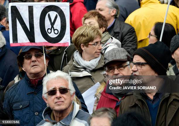 Demonstrators march in Madrid on March 17 during a protest called by the main Spanish unions and the 'State Commitee to Safeguard Pensions' , to...