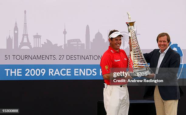 Lee Westwood of England poses with the Race To Dubai trophy alongside George O'Grady, Chief Executive of The European Tour, after winning the Dubai...