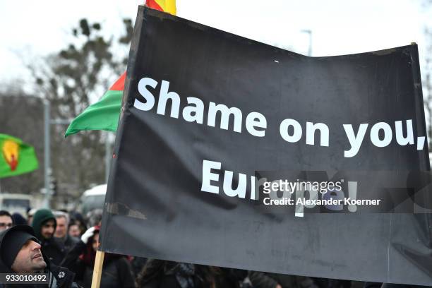 Expatriate Kurds hold a banner reading "Shame on you, Europe" and shout slogans against Turkish President Recep Tayyip Erdogan as they participate in...