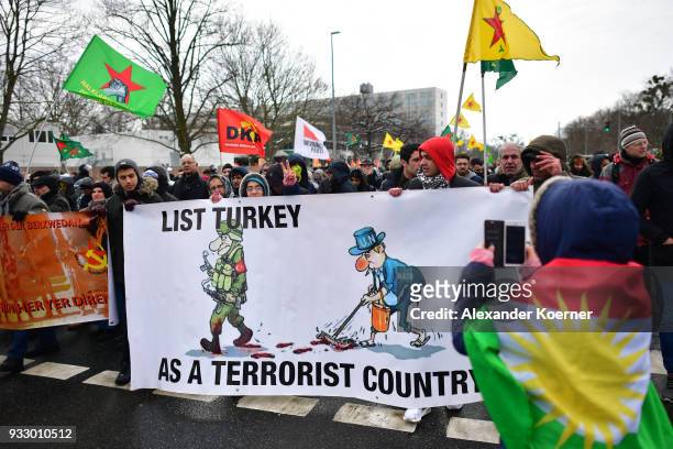 Expatriate Kurds hold a banner reading "List Turkey as a terrorist country" as they participate in celebrations marking the Kurdish new year, or...